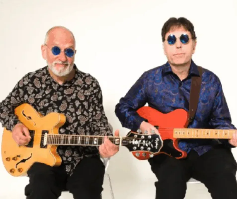 Two musicians playing electric guitars.